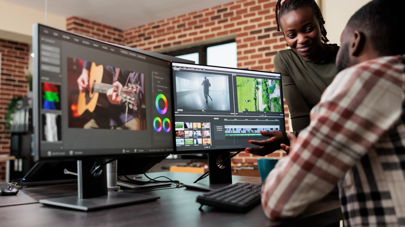 post-production-department-leader-advising-colleague-improve-colors-frames-quality-footage-creative-professional-video-editors-collaborating-order-finish-film-project-upon-deadline-scaled
