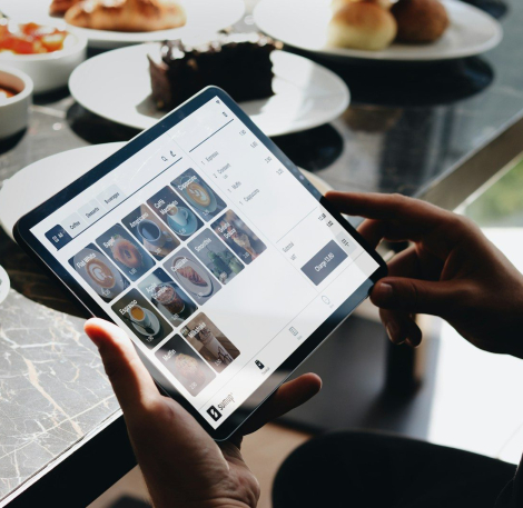 A person sitting at a table with a tablet